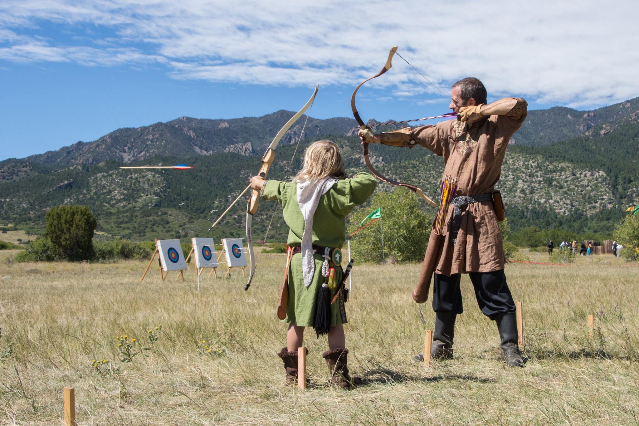 Two people shooting archery