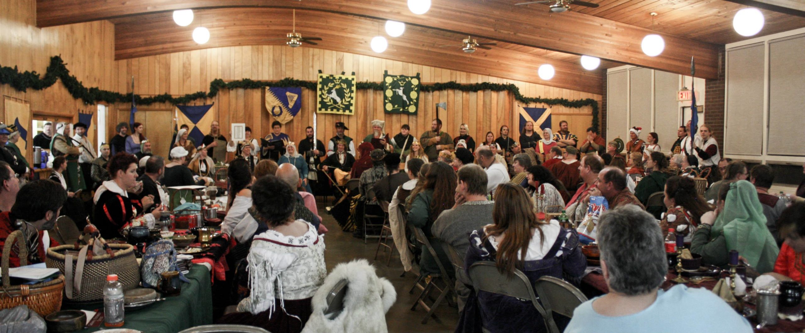 People eating feast during a court in a decorated hall