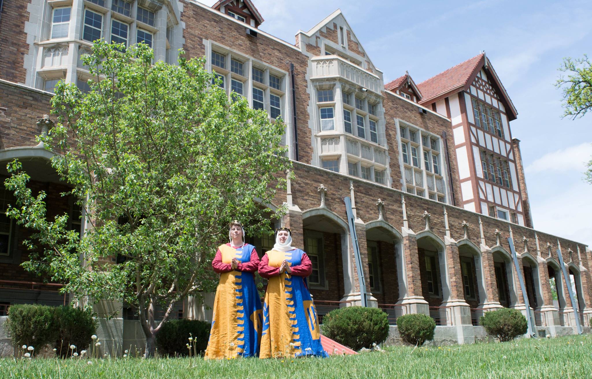 Two people standing in front of a church