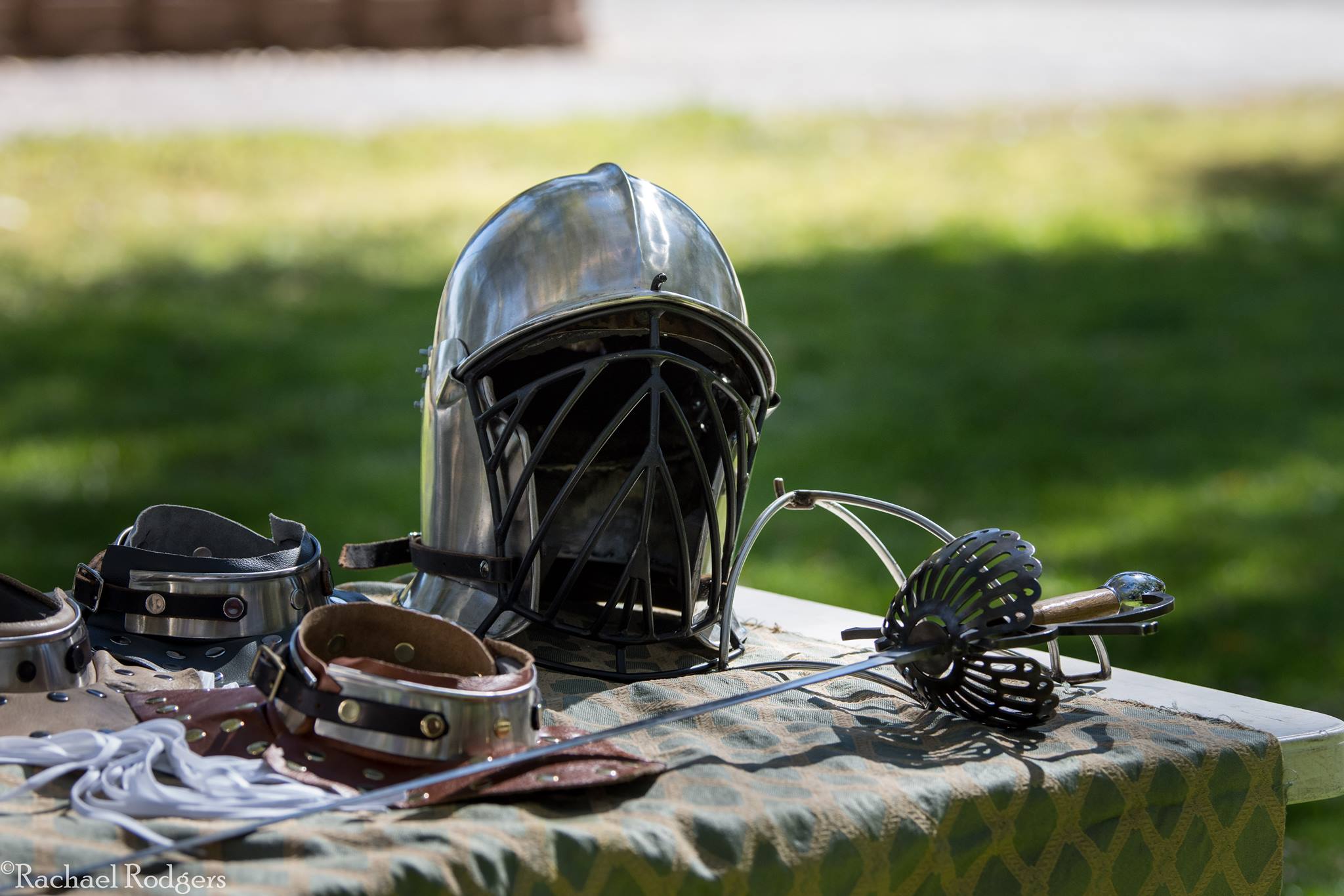 A helmet, rapier, and pieces of armor