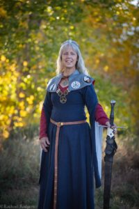 A woman in new regalia with a sword