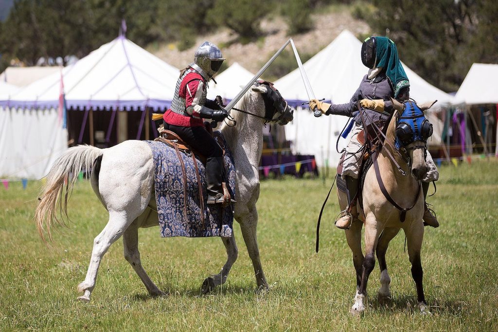 Two riders on horses fencing. Photo by William Colburn.