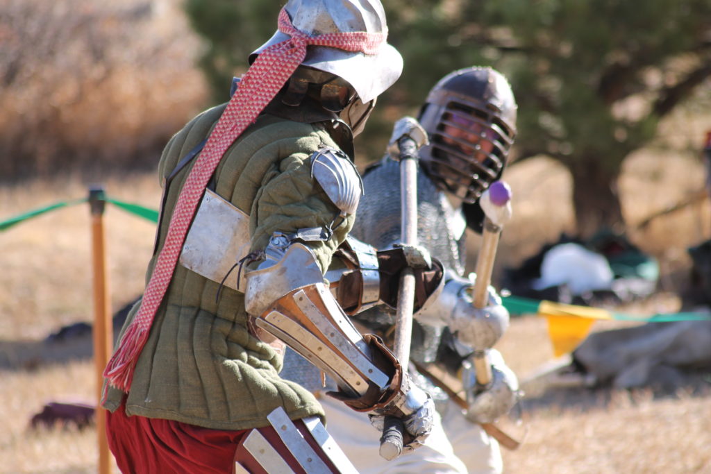 Armored combatants spar with spears