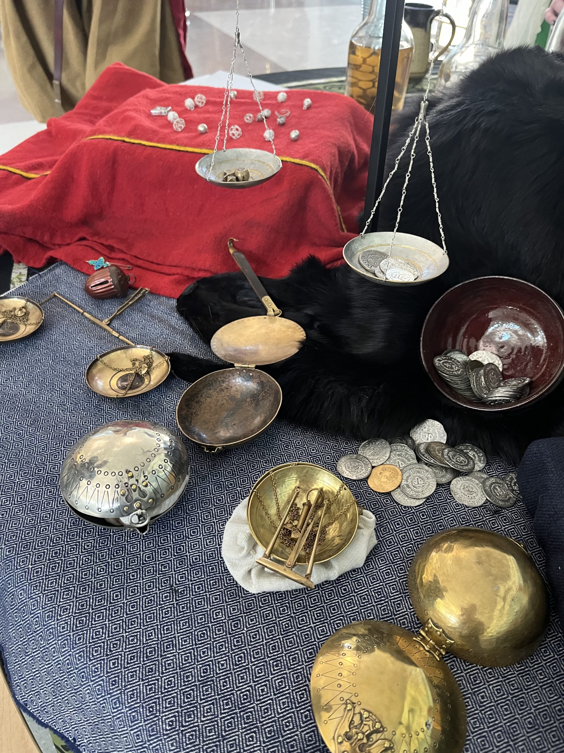 A group of scales and coins, arranged on a table